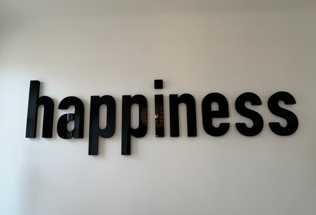 Happiness logo on wall